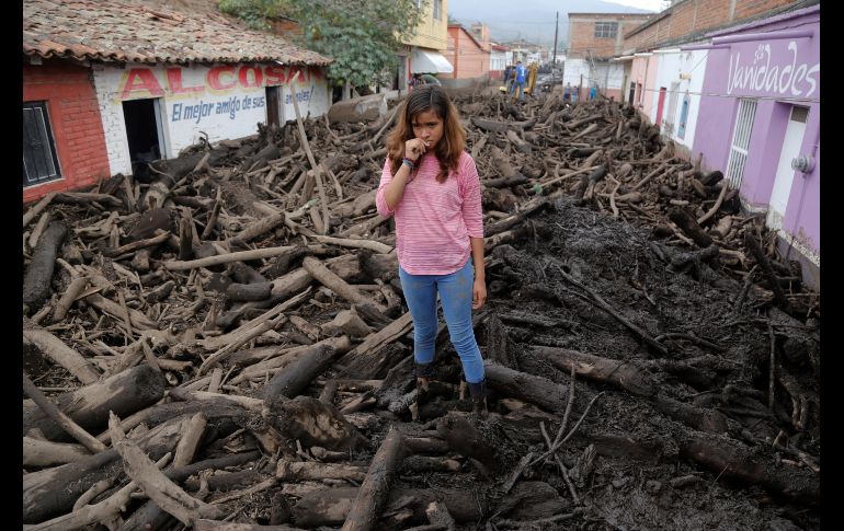 Troncos arrastrados por lluvia quedaron en una calle de San Gabriel el 3 de junio, luego del desbordamiento del río de Apango un día antes que cobró la vida de cinco personas. EFE