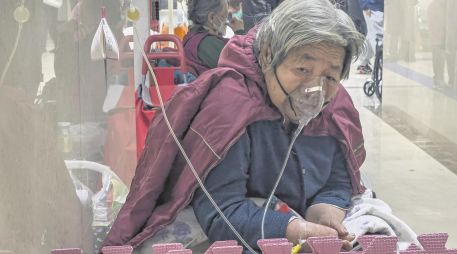 Una paciente está conectada a un ventilador en el pasillo de la sala de emergencias de un hospital en Beijing. La repentina reapertura de China dejó a las personas mayores vulnerables. AP