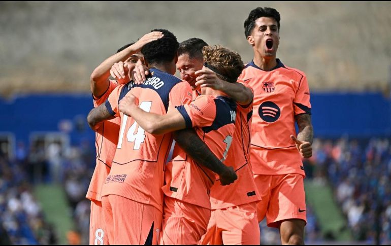 El Barça se afianza en el liderato del campeonato, ahora con una amplia ventaja de once puntos sobre el Real Madrid, a falta de cinco jornadas y quince puntos por disputarse. AFP / J. Soriano