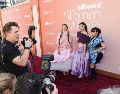 Las cantantes coreanas Audrey Nuna (izquierda), EJAE (centro) y Rei Ami (derecha) llegan a la alfombra roja de los premios Billboard Woman in Music Awards en el Hollywood Palladium de Hollywood, California. EFE/C. TORRES