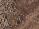 Imagen por satélite que muestra un tramo de una barrera de tierra construida por el ejército israelí, desde el lado derecho de la imagen y hacia abajo, en el centro de la Franja de Gaza, el 1 de julio de 2026. A la izquierda se ve el campo de refugiados de Maghazi, y al otro lado casas demolidas por el ejército. AP/Planet Labs PBC via AP)