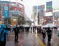 Un equipo de televisión realiza un reportaje cerca del cruce de Shibuya bajo las fuertes lluvias provocadas por el tifón Dujuan en Tokio, Japón, el 21 de septiembre de 2026. EFE/F. ROBICHON